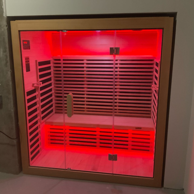 Red light therapy box with glass door on a white background